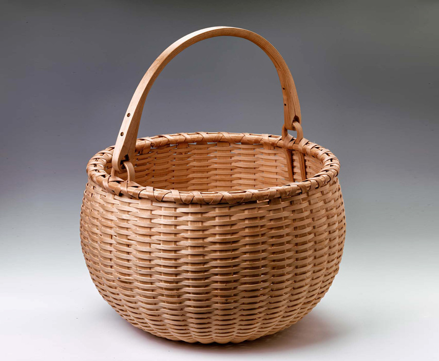 Swing Handle Apple Basket. Hand crafted of brown ash by Maine basket maker Stephen Zeh.