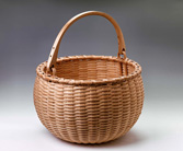 Swing Handle Apple Basket handwoven of brown ash by Stephen Zeh, Maine basket maker.