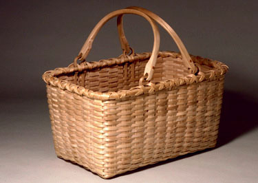 Double Swing Handle Oval Carrier - hand woven of brown (black) ash. Hand crafted by Stephen Zeh, Maine basketmaker