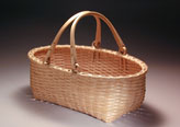 Swing Handle Oval Carrier hand crafted of brown or black ash by Stephen Zeh Basket Maker of Temple, Maine.