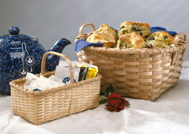 Bread Basket - square bottom to round top. On table filled with blueberry muffins, with tea basket, teapot and rose. Handcrafted basket by Stephen Zeh, Maine basketmaker.