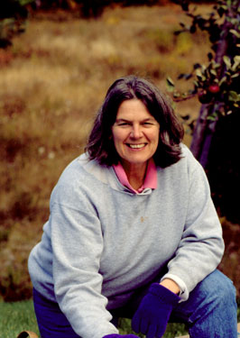 Tammy Zeh harvesting apples in the orchard