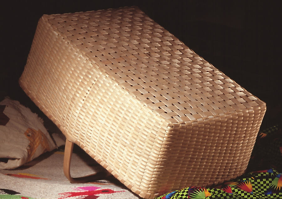 Quilt Basket bottom view - a large rectangular basket with overhead handle finely woven of brown (black) ash. Hand crafted by Stephen Zeh, Maine basketmaker