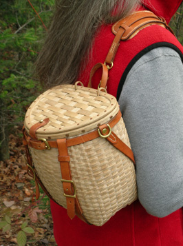 Maine Packbasket Purse worn over the shoulder showing shearling shoulder pad - brown ash, brass, leather - by Stephen Zeh
