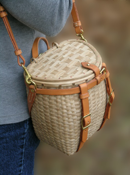 Maine Packbasket Purse worn at side - brown ash, brass, leather - by Stephen Zeh