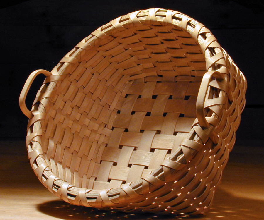Bread Basket side view - square bottom to round top. Handcrafted of brown / black ash by Stephen Zeh, Maine basketmaker. 