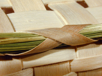 Sweetgrass Tray detail showing sweetgrass footer to protect bottom. Hand crafted of brown (black) ash and sweet grass by Stephen Zeh basket maker of Temple, Maine.